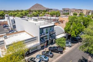 an aerial view of a building with cars parked in a parking lot at LUX at Craftsman - Heart of Old Town Studio 1 in Scottsdale