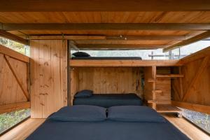 a bed in the inside of a wooden cabin at Stunning cabin in Baños in Baños