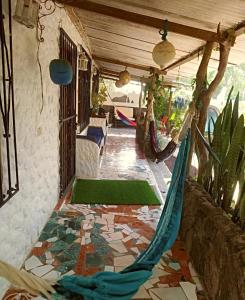 a porch with a hammock on a patio at La casa de los Ciprés in San Cristobal