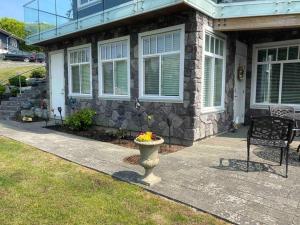 a house with a vase with flowers in front of it at White Rock Beach getaway in White Rock