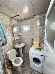 a small bathroom with a toilet and a sink at Lux Apartment+Terrace in Mardin