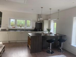 a kitchen with a large island with two bar stools at Cunningham in Nottingham