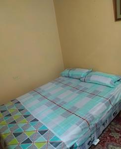 a bed in a corner of a room at La casa de los Ciprés in San Cristobal