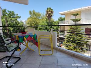 a patio with a table and chairs on a balcony at Smart home,voice activated apartment in kalamata in Kalamata