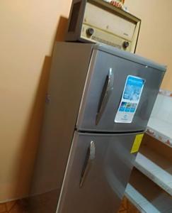 einen Kühlschrank mit einem Telefon darüber in der Unterkunft La casa de los Ciprés in San Cristobal