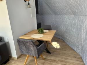 a wooden table and two chairs in a room at Glamping u oveček in Ivančice