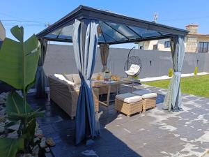 a gazebo with a table and chairs on a patio at sand and sea in Póvoa de Varzim