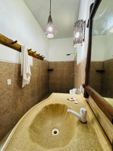 a bathroom with a sink and a mirror at Rancho do Buna in Atins