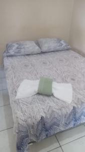 a bed with two pillows on top of it at Hostel ANGATU in Salvaterra