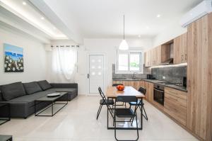 a kitchen and living room with a couch and a table at Asterashouse in Rhodes Town