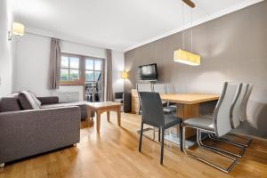 ein Wohnzimmer mit einem Sofa und einem Esstisch in der Unterkunft Apartment Select TOP 8 - by Four Seasons Apartments in Piesendorf