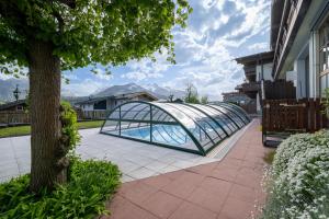 a glass bridge over a swimming pool in a yard at Apartment Select TOP 8 - by Four Seasons Apartments in Piesendorf