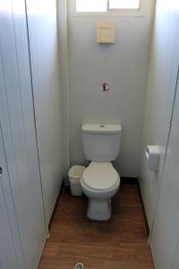 a small bathroom with a toilet and a window at Bamboo Paracas Resort in Paracas