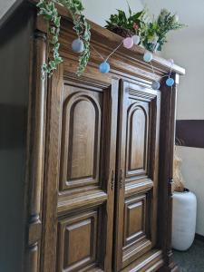 a wooden cabinet with christmas lights on top of it at Vintage-Zimmer mit Balkon in Felsberg