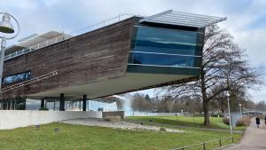 a building with a glass facade in a park at Altstadtliebe Konstanz - harmonischer Luxus in Konstanz