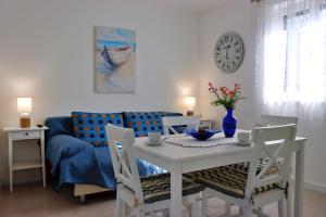 a living room with a table and a blue couch at Holiday house Silvana in Ždrelac +27 photos