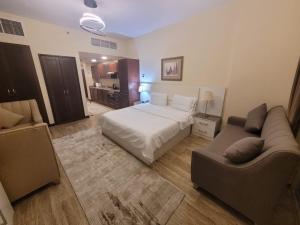 a hotel room with a bed and a couch at Royal Lotus in King Abdullah Economic City +10 photos