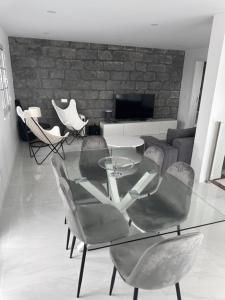 a glass table and chairs in a living room at Furna Blue View in Lagoa