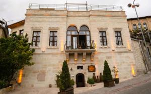 a building with a balcony on top of it at Yeşil Konak Cave Hotel in Ürgüp