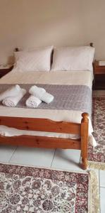 a bed with towels and pillows on it at Lambrinis house in Kanallákion