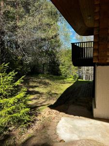 a porch of a house with a view of a yard at Vizbuļi, Amatciems in Amatciems