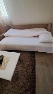 a bedroom with two beds and a table at Konak in Novi Pazar