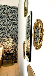 a pair of mirrors on a wall in a room at Cuore Barocco in Noto