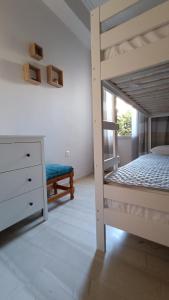 a bedroom with a bunk bed and a dresser at Katerina Holiday House in Anavyssos