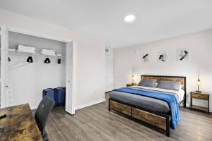 a white bedroom with a bed and a table at Home Sweet Home - near NWK & NYC w/free parking in Newark