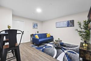 a living room with a blue couch and a table at Home Sweet Home - near NWK & NYC w/free parking in Newark