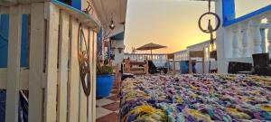 a bed on the side of a building at Free birds hostel in Tamraght Ouzdar