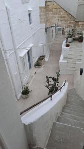 a view of a building with stairs and plants at La Corte delle Arti in Matino