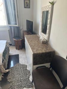 a dressing room with a mirror and a chair and a rug at Laila in Creil