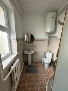 a small bathroom with a toilet and a sink at Дом Жени и Люды in Zhabagly