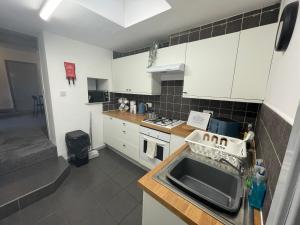 a kitchen with a sink and a counter top at Westminster-3 Bdrm 1 EnSuite Fab for contractors 2-5 Bath Free Parking Wi-Fi in Gateshead +32 photos