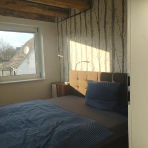 um quarto com uma cama e uma janela em Zum alten Schmied Vermietung und Verpachtung Schönfeld 