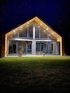a house with lights on the front of it at night at Casa Tinca 2 in Izvoru Mureşului