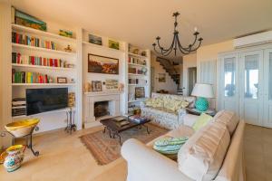 a living room with a couch and a fireplace at Sea View Villa Taormina in Taormina