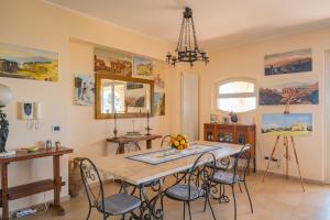 a dining room with a table and chairs at Sea View Villa Taormina in Taormina