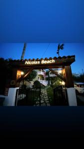 a sign for a mexican beach restaurant at night at Nicolas Beach in Palaiochóra