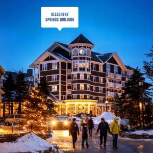 a group of people walking in front of a large building at Allegheny222, Hot Tub,Pool,Ski InOut,Village in Snowshoe