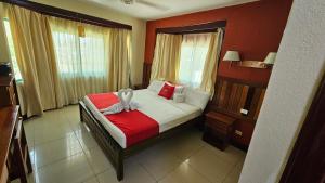 a bedroom with a bed with a towel on it at Caye Caulker Plaza Hotel in Caye Caulker