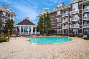 a courtyard with a swimming pool in front of a building at Allegheny222, Hot Tub,Pool,Ski InOut,Village in Snowshoe