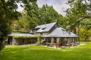 a stone house with a gambrel roof at Judge & Jury Farm Retreat in Gibbston