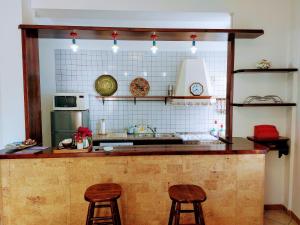 a kitchen with two bar stools and a counter top at casa panoramica in Teulada