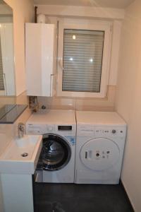 a kitchen with a washing machine and a window at Villa Amela in Ilidža +43 photos