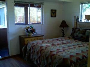 a bedroom with a bed and a table with flowers on it at Redrockescapes in Sedona