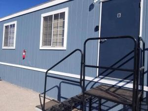 a blue trailer with a ramp leading to a door at 075B Affordable Retreat nr South Rim Sleeps 2 in Valle