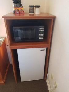 a microwave sitting on top of a table with a refrigerator at 075D Cozy Retreat nr South Rim Sleeps 2 in Valle