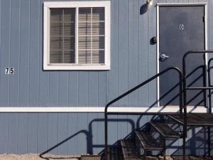 a blue house with stairs in front of a door at 075D Cozy Retreat nr South Rim Sleeps 2 in Valle